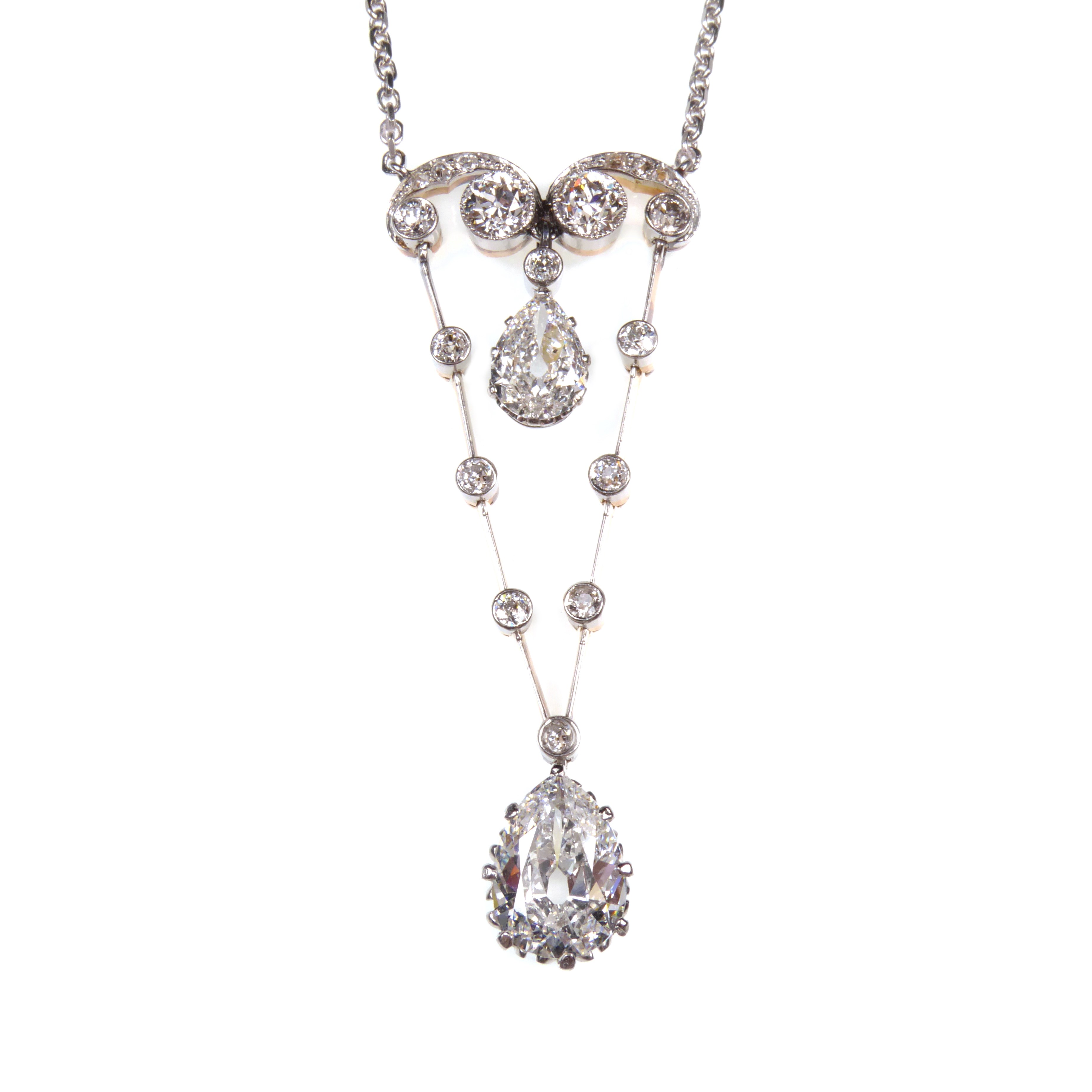 Antique pear shaped diamond and scroll pendant necklace, c.1900, hung with a 2.07ct F VS1 old pear brilliant cut diamond,